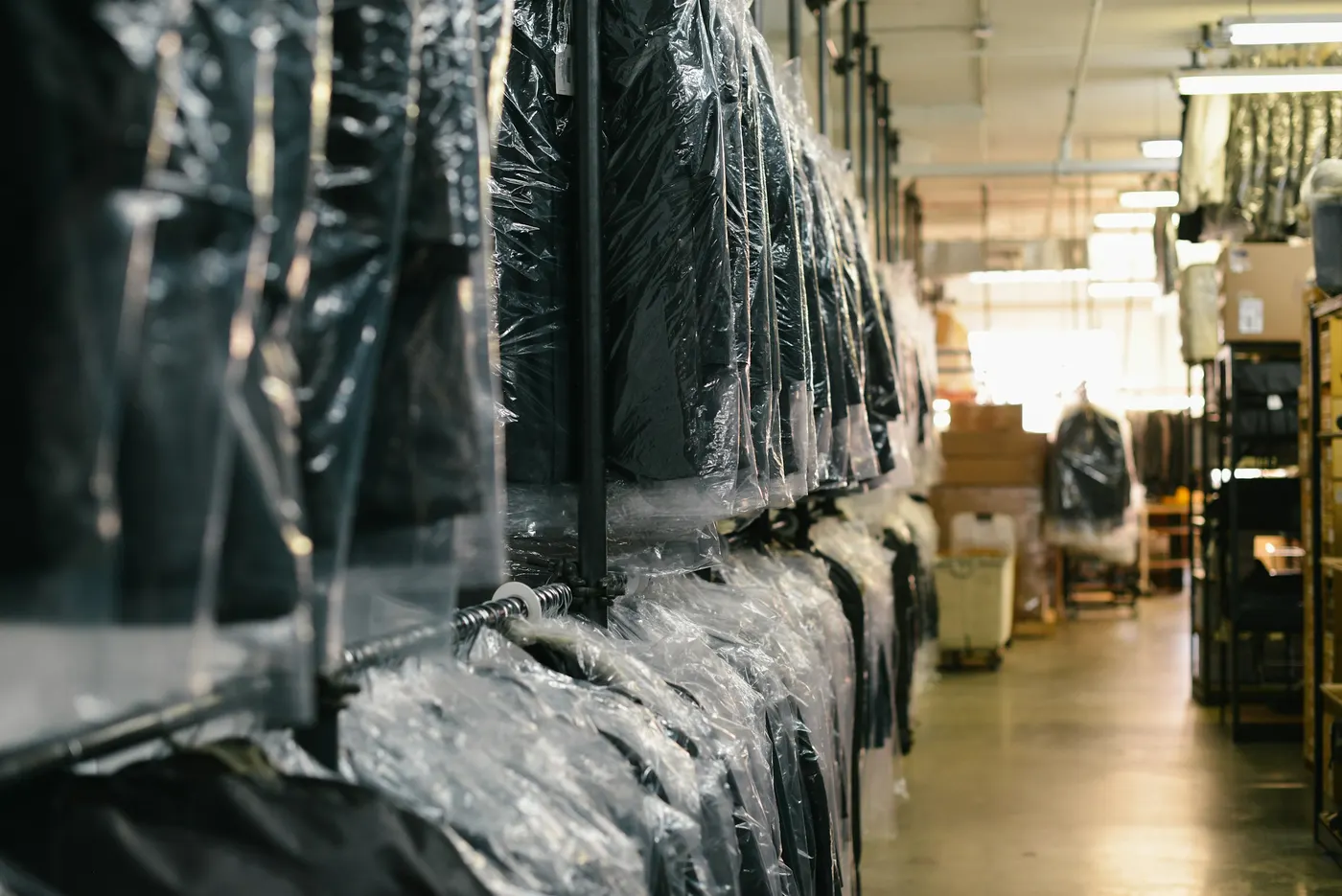 Dry-cleaned garments hanging in dust-proof covers