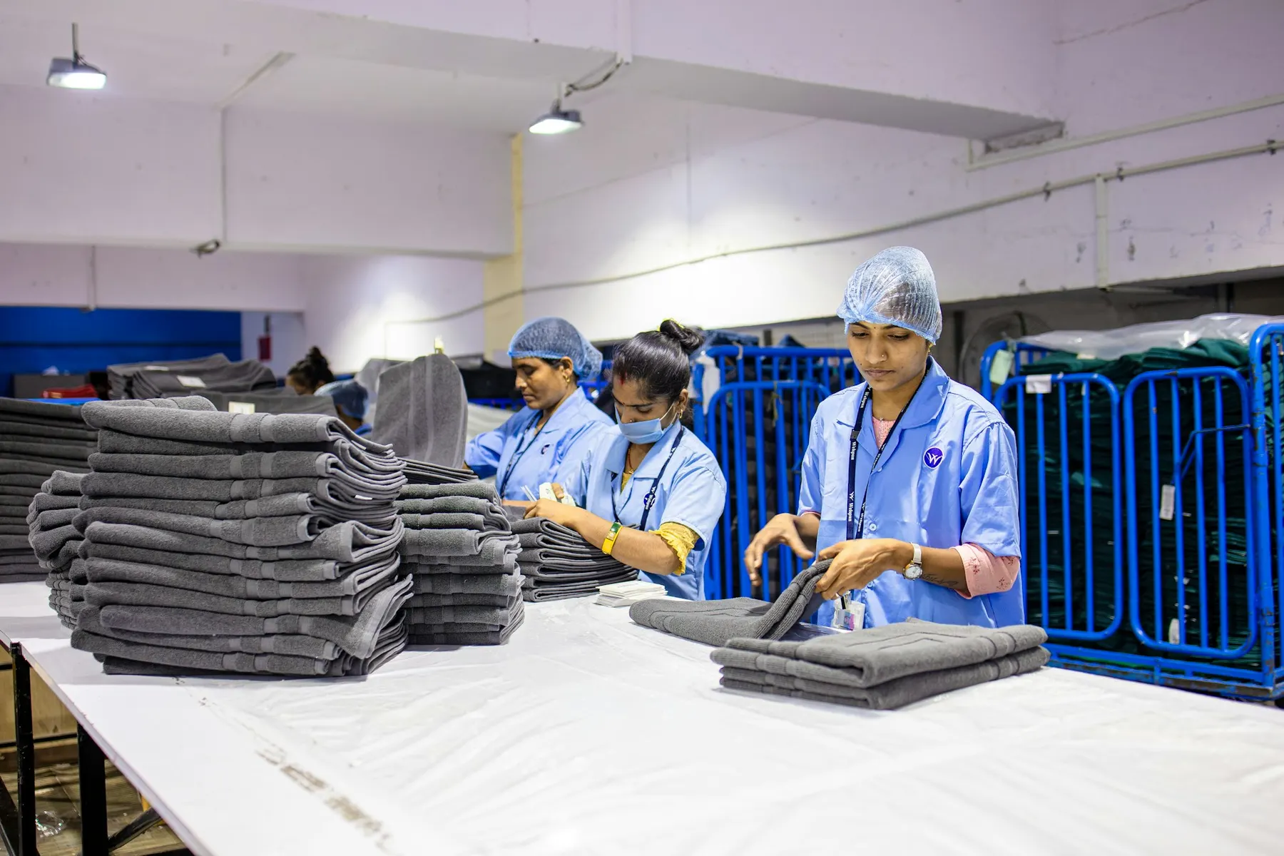 Laundry team folding fresh linen